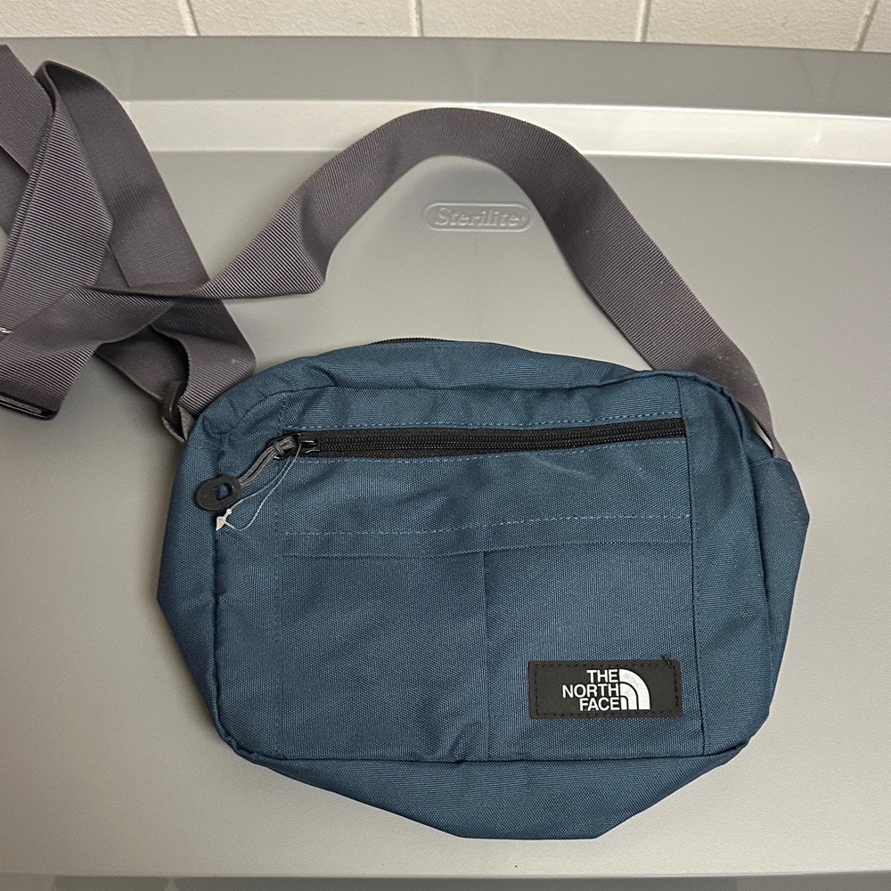 The North Face Navy Blue Crossbody Bag with Gray Strap